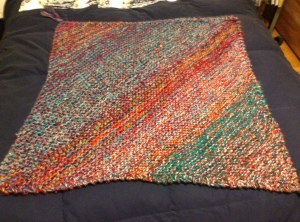 This is the finished blanket, which should look mostly purple and reddish. Used lots of blue, teal, turquoise, purple. I undid what I had started (previous pic) to switch to larger needles.